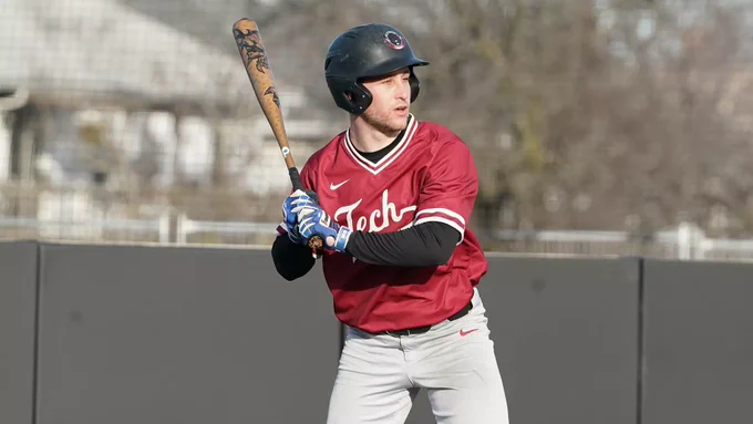 Eitan Moore of MIT Baseball in a red jersey holding a bat and waiting for the pitch