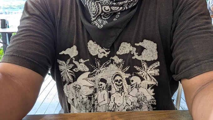 A black t-shirt with skeletons wearing baju Raya. 