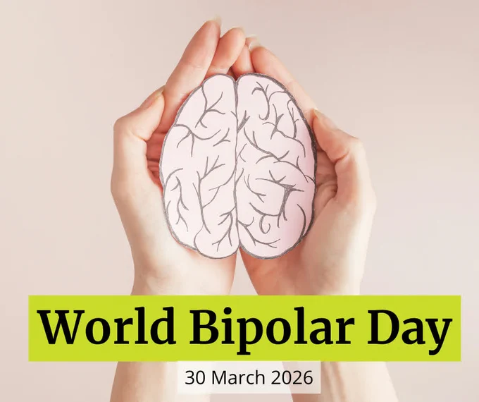 Photo of hands cradling a drawing of a human brain. Text reads ‘World Bipolar Day.’ 
