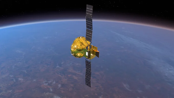 A shiny, golden spacecraft at the centre of the frame stretches out its two solar panels towards the top and bottom. The panels are not quite fully stretched, with two slight bends in each. In the background, we see Earth, with the horizon curving from left to right across the top third of the frame.