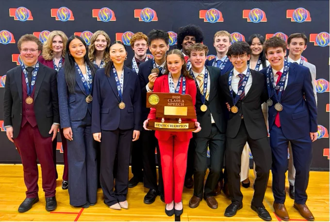 A group photo of the East Speach team displaying their awards and medals.