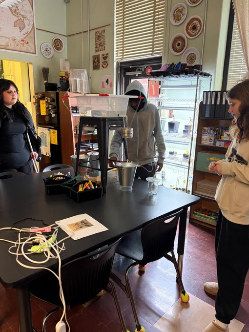 Students watching to see if their electrical circuit is going to work.