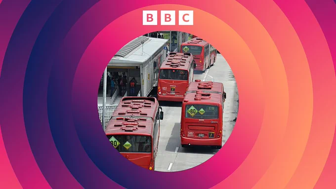 A group of red public buses is lined up at a station with people boarding one of them. The scene is framed by a colorful, circular gradient. The BBC logo is at the top.