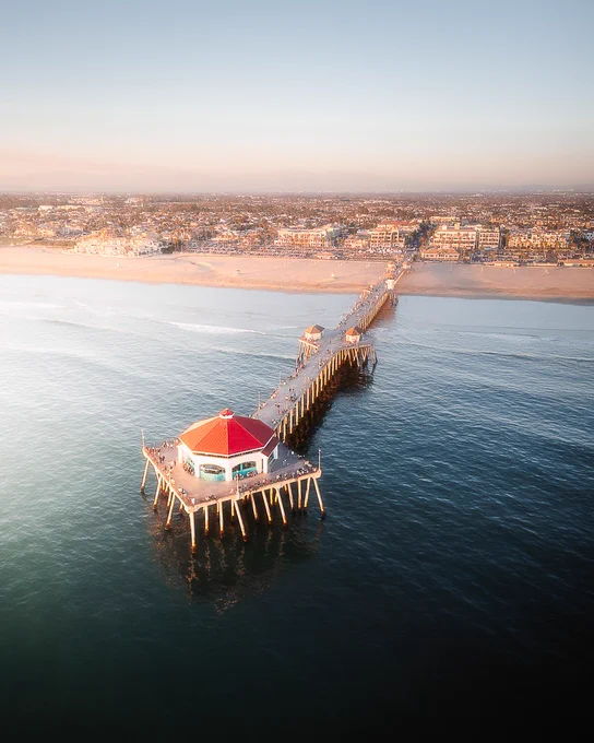 Aerial view of the Huntington Beach Pier extending into the ocean.