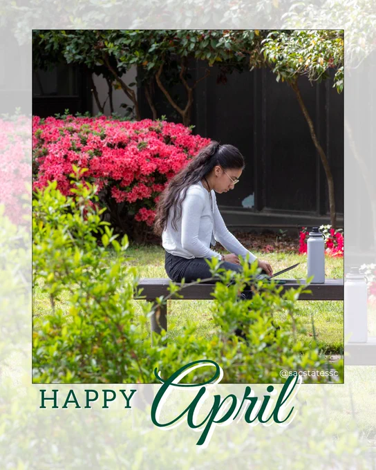 A person sits on a wooden bench outdoors in a garden, working on a laptop. They are surrounded by green plants and bright pink flowering bushes, with trees and a building in the background. A reusable water bottle sits beside them on the bench. Overlaid text at the bottom reads “Happy April.”