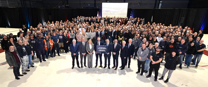 Group photo of numerous attendees at a conference or meeting, with key figures positioned prominently in front.