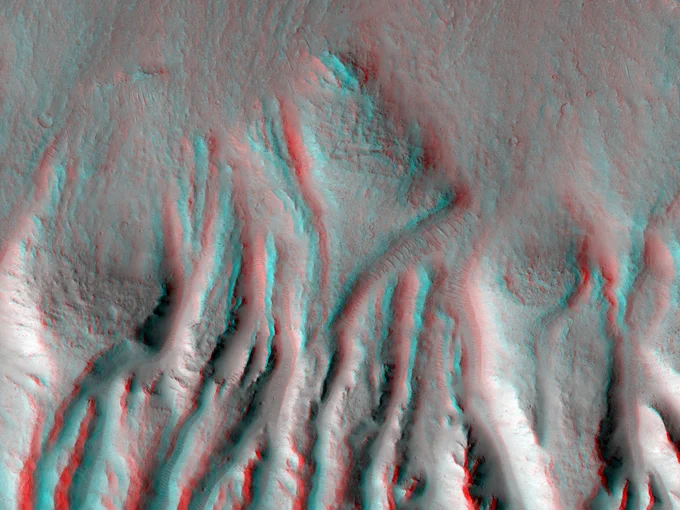 3D anaglyph image showing rugged terrain with deep vertical ridges and valleys, creating a textured landscape effect.