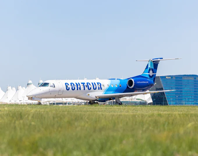 A Contour Airlines airplane taxis on the airfield at DEN.