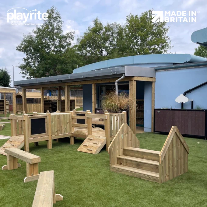 Wooden trim trail on artificial grass outdoors in children's playground at a primary school