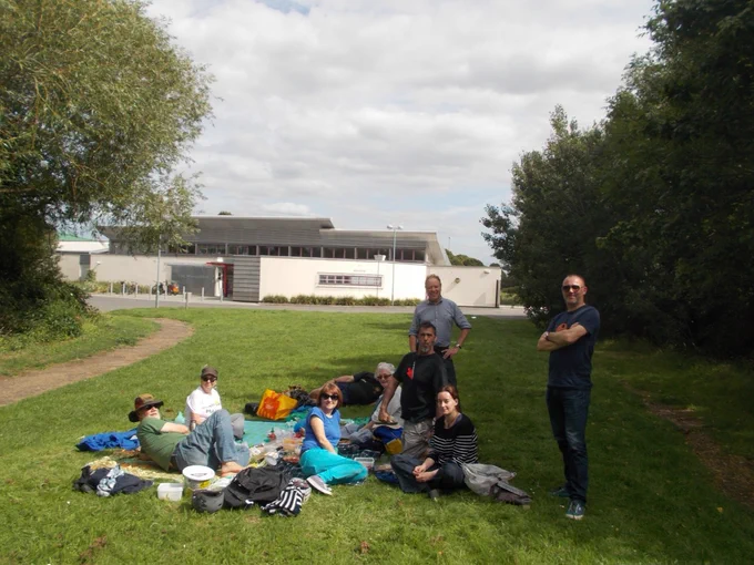 A group of people gathered on the green space outside the Waterworks Centre, East London, 2017