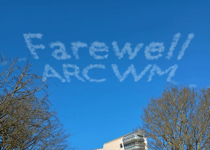 A blue sky above UHBFT hospital with sky-writing saying 'Farewell ARC WM'