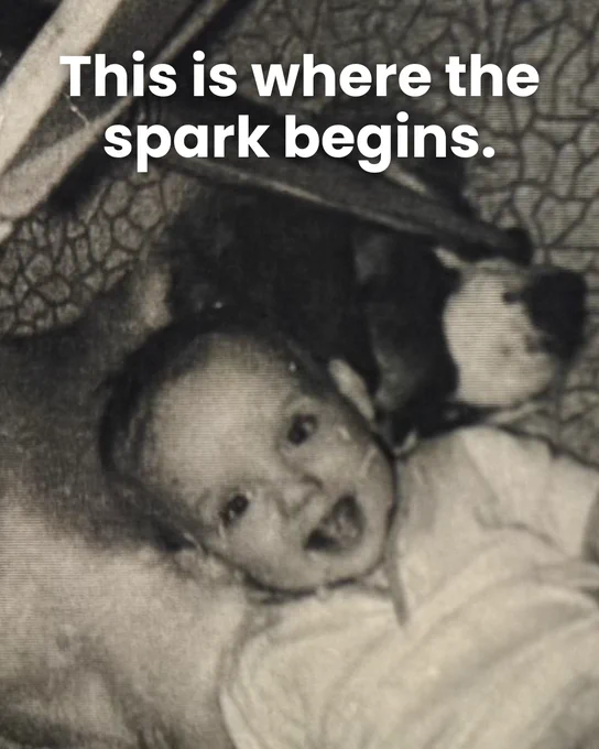 "This is where the spark begins" text with image of Ken as an infant smiling laying on the floor with his dog
