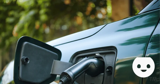 Electric car with charging cable plugged in. EVcourse logo. 