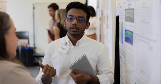 Rizwanul is talking to someone about his poster.