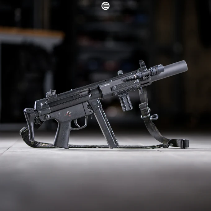 RailScales QTR Stop, RSBM-P Polymer M-LOK VFG, HTP MLOK Scales (Dragon, Black, 2.5-Slot), HTP Solo's (Dragon, Black, 1.5-Slot), Hardtop Mount for Scout Light Pro Lights | Heckler & Koch MP5SD, Hitec Arms HP5SD Receiver, Dakota Tactical MHS-SD M-LOK Rail w/ The One Cage, B&T USA MP5SD Suppressor, Surefire M340C-Pro Light w/ CSM-07 Pressure Switch, Ferro Concepts MultiCam Black Slingster w/ Blue Force Gear ULoop Sling Attachments, HK MP5 30rd Straight Mag, HK SEF Trigger Housing, HK SEF Full Auto Trigger Pack, HK SEF Long Axle Selector Lever, HK MP5 A3 Retractable Buttstock. 