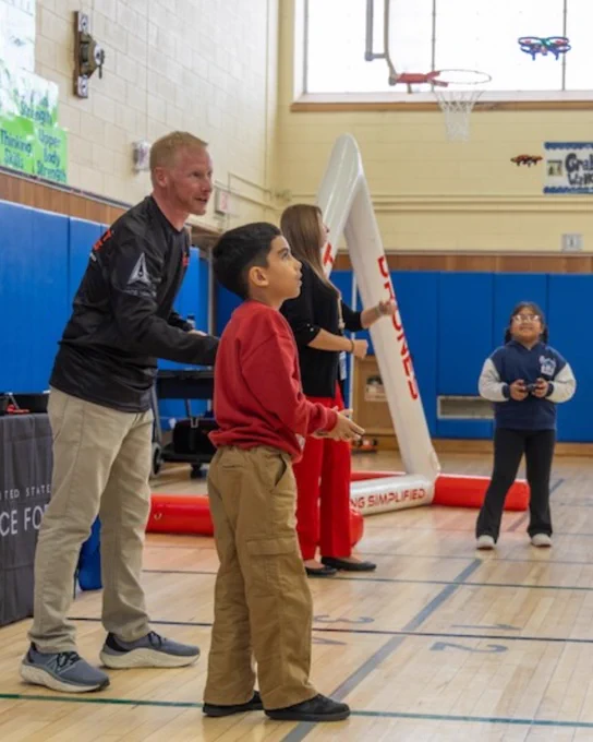 Drone instruction teaching young student how to fly a drone.