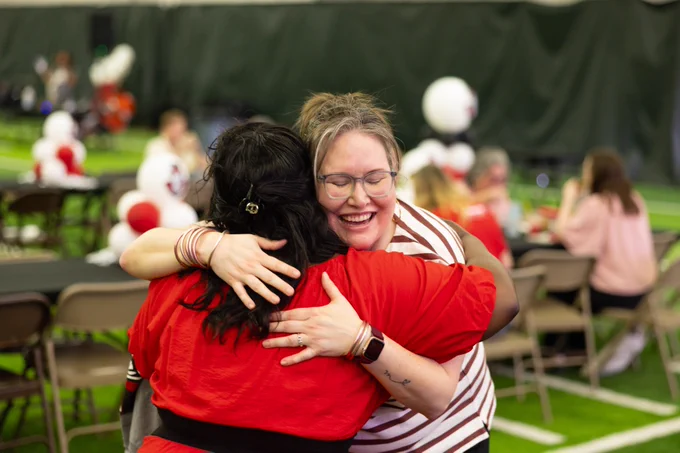 Two employees hugging each other during the Employee Appreciation Day event at Austin Peay State University. 