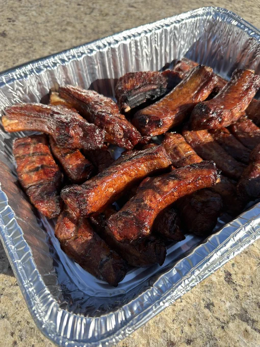 “Party ribs” technique of slicing ribs down to individual bones and slow smoking until tender, much faster cook and more bark per rib. Delicious