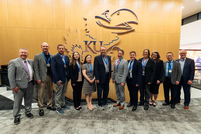 Professors wearing award medallions pose for a photo at the University of Kansas 2026 University Research Awards ceremony.
