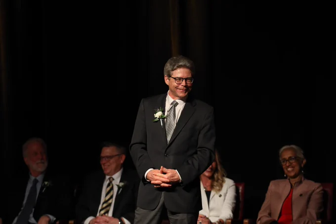 Jeff Russell, UW-Madison Dean of Continuing Education and Professor of Civil and Environmental Engineering wearing a suit and tie and smiling at an award ceremony.