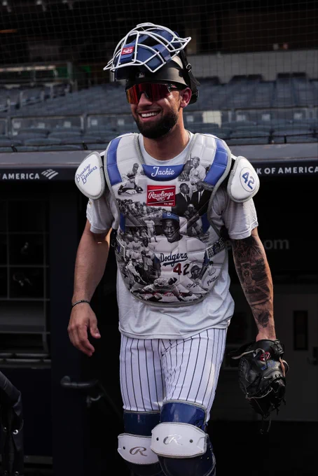 J.C. Escarra takes the field Wednesday for warm-ups. He has Jackie Robinson imagery collaged all over his chest protector with number 42 on the left shoulder pad and "Breaking Boundaries" on the right shoulder pad. (Photo: Michael Mooney/Major League Baseball)