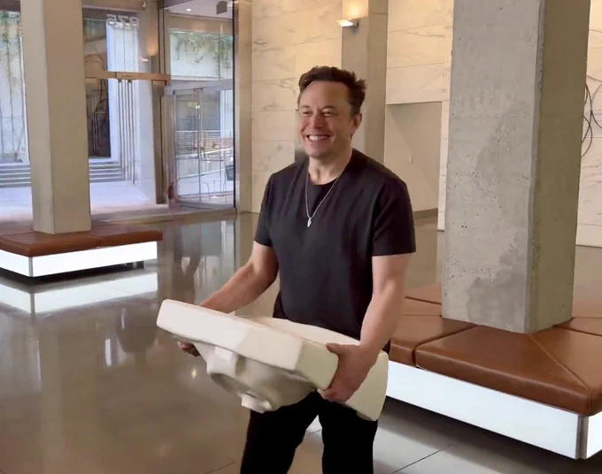 Elon Musk entering Twitter HQ after having bought the company.