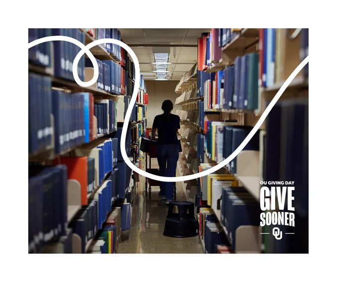 A person is walking through a library aisle filled with books on both sides. The image has a graphic overlay with the text "OU Giving Day" and "Give Sooner."