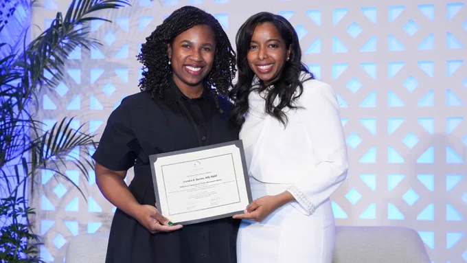 Dr. Leandra Barnes receives the 2026 SOCS Career Development Award, presented by Dr. Nada Elbuluk at the 22nd Annual SOCS Scientific Symposium. 