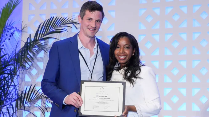 Dr. William Lewis receives the 2026 Dermatology Research Award at the 22nd Annual SOCS Scientific Symposium, presented by Dr. Nada Elbuluk.