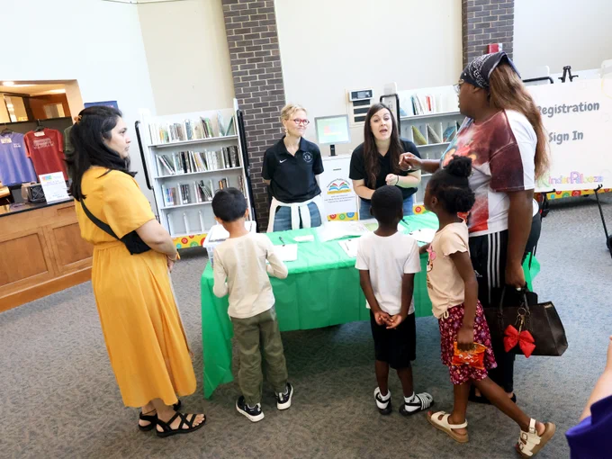 Families receiving information about Kinderpalooza event at the Tuscaloosa Public Library