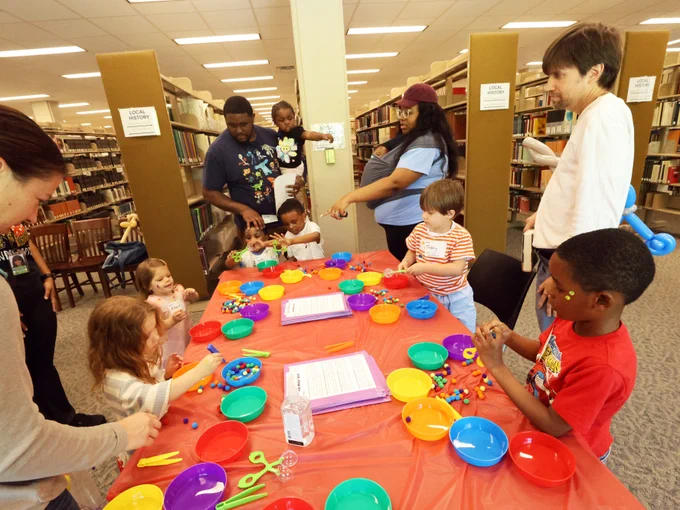 Families enjoying Kinderpalooza event at the Tuscaloosa Public Library