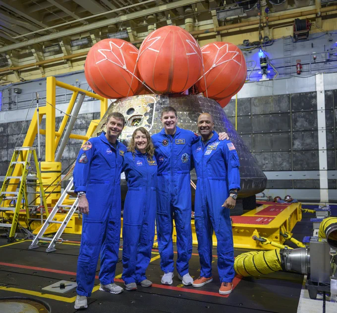 The crew of Artemis II (from left: Reid Wiseman, Christina Koch, Jeremy Hansen, Victor Glover) pose for a group photo after viewing the Orion spacecraft in the well deck of USS John P. Murtha in the Pacific Ocean off the coast of California. Credit: NASA/Bill Ingalls