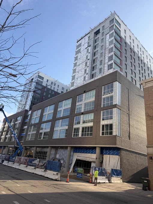 Exterior view of Theory Madison Student Housing near the University of Wisconsin-Madison campus, a sustainable urban redevelopment project featuring critical safety infrastructure installed by Luminous Egress of Chandler, Arizona for Mortenson Construction.