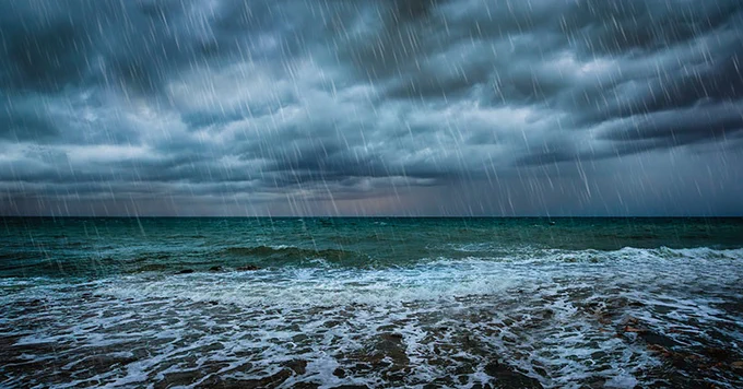 rain and clouds over choppy waters