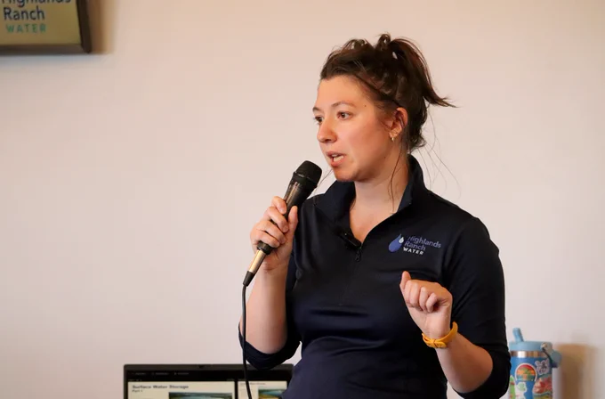 Woman speaking into a microphone.