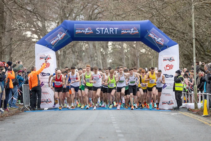 a picture from the start line of the inverness half marathon, with runners in running vests getting underway