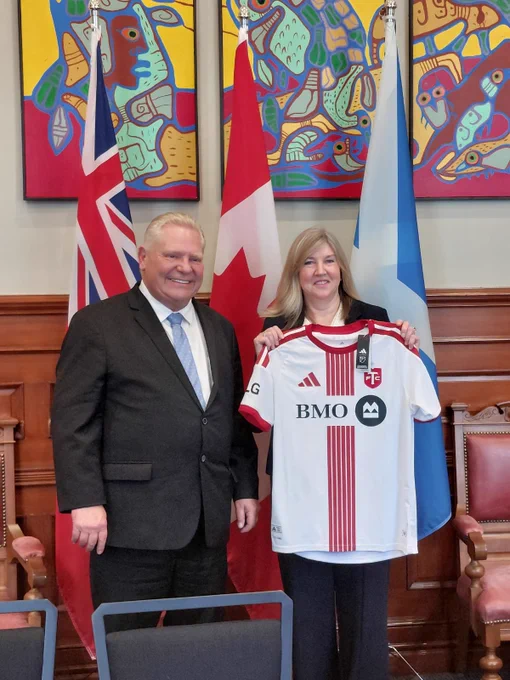 Premier of Ontario Doug Ford MPP presents Alison Johnstone with an Toronto FC top.
