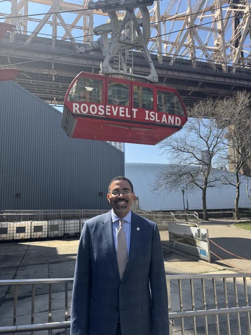 Chancellor King in front of the Roosevelt Island tramway.