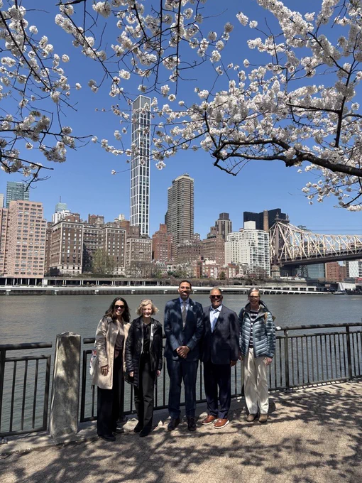 Chancellor King and Cornell Tech leadership on  Roosevelt Island with New York City behind them.