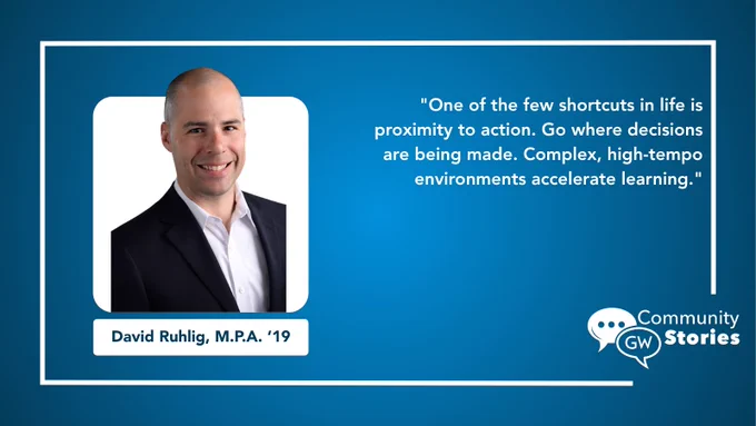 This image features an individual in a suit with a shaved head, smiling. Next to them is a quote about the importance of being close to action and decision-making for learning. The quote discusses high-tempo environments. The bottom includes a name, "David Ruhlig, M.P.A. ’19," and the logo for George Washington University Community Stories.