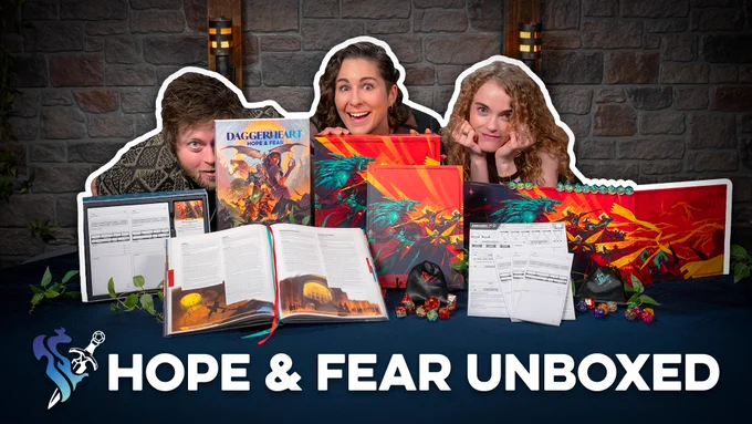 Photo of Daggerheart devs Spenser, Elise, and Rowan in front of the Daggerheart expansion Hope & Fear standard and deluxe versions.