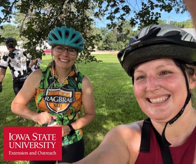 two women riding bikes outside in the summer