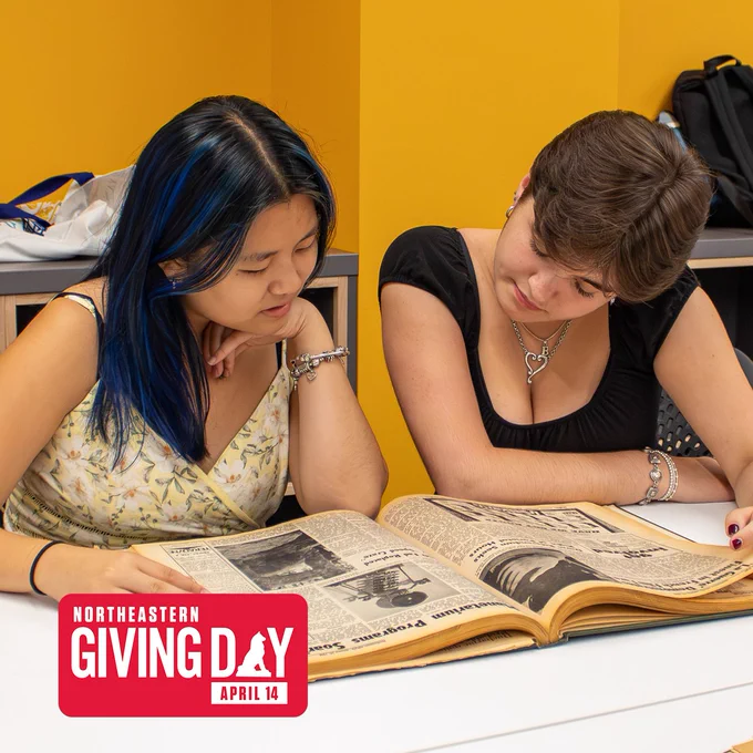 Two people sit at a table and look at a bound book of archival newspapers.

Photo: Margot Murphy/Huntington News