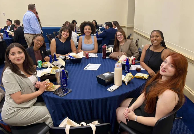 Group of CSU students sitting at a round table.