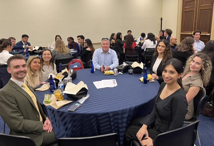 Group of CSU students sitting at a round table.