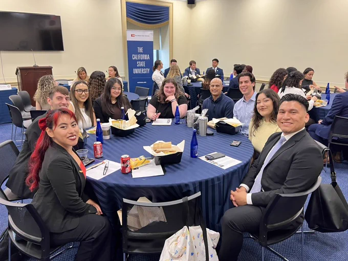 Group of CSU students sitting at a round table.