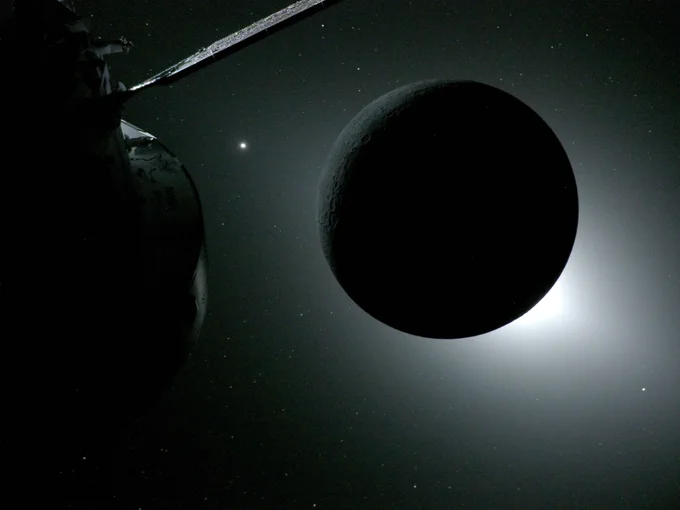 A solar eclipse, captured from a camera mounted on one of the Orion spacecraft\u2019s solar array wings during the Artemis II crew\u2019s flyby of the Moon\u2019s far side. The Moon is dark, save for a bright halo of white light surrounding it. The Orion spacecraft is in the leftmost half of the image, mostly shadowed.