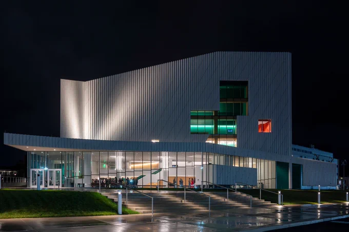 Exterior of modern building at night with lights shining on it