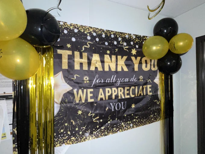 Sign, banners, and balloons that say "Thank you for all you do, we appreciate you."
