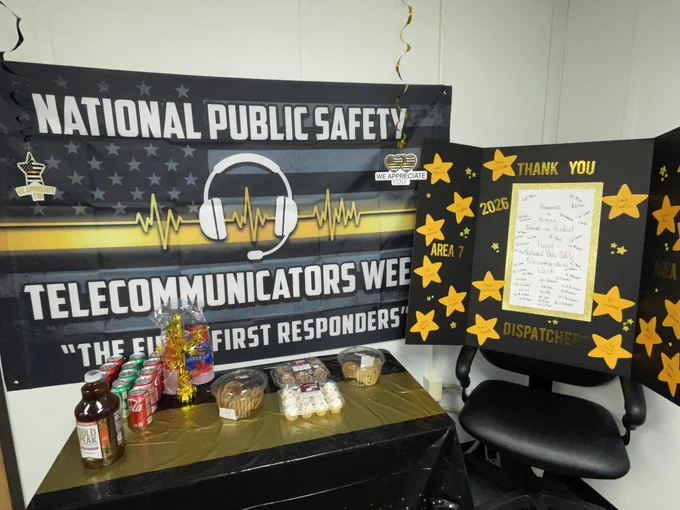 Signs, thank you notes, free foods and drinks, and a banner that says "National Public Safety Telecommunicators Week"